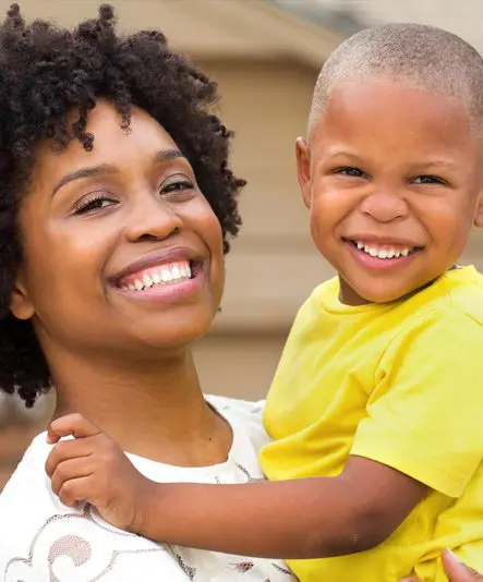 A woman and child smiling for the camera.