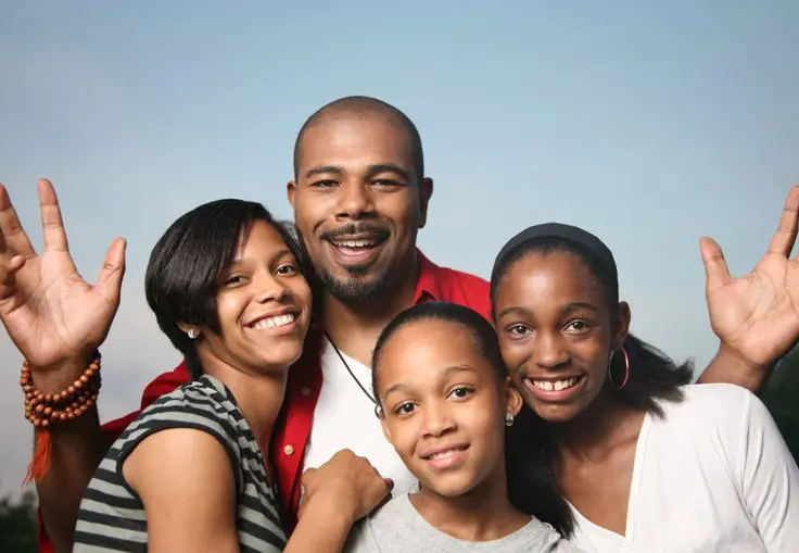 A family of four posing for the camera.